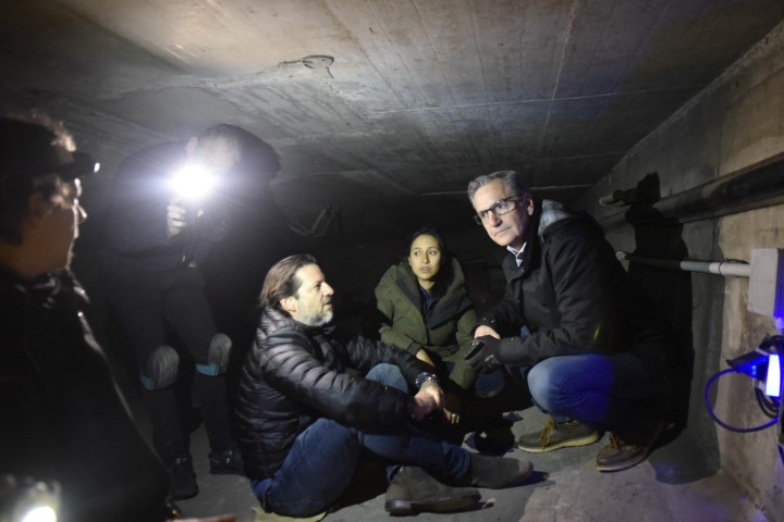 Yosbany Ballat, Katherine Farley, and Don Kline crouching in concrete structure